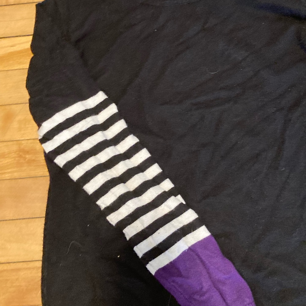 Renee C. Black, purple and white long sleeve.